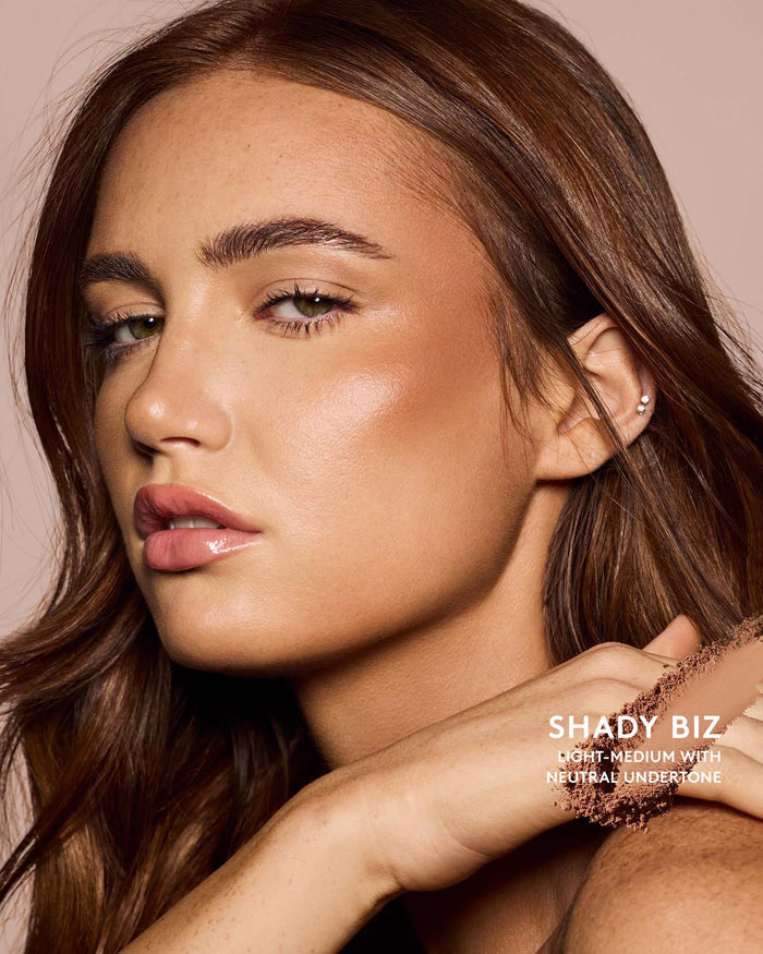 Light-Medium skin tone model wearing sun stalk'r bronzer in shade Shady Biz.