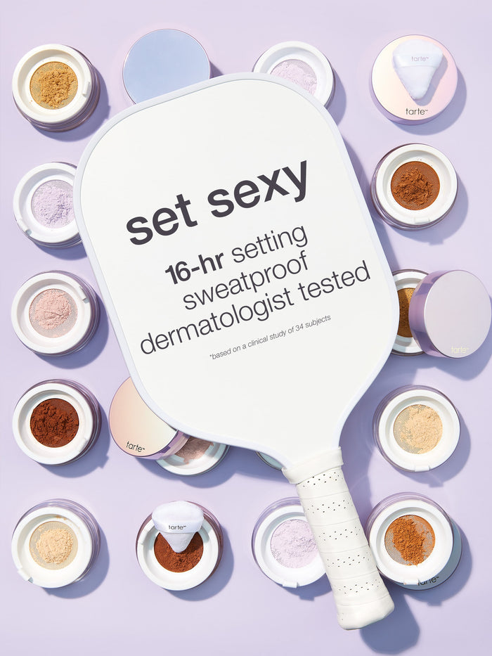 Makeup setting powder paddle with 'set sexy' text on a purple background