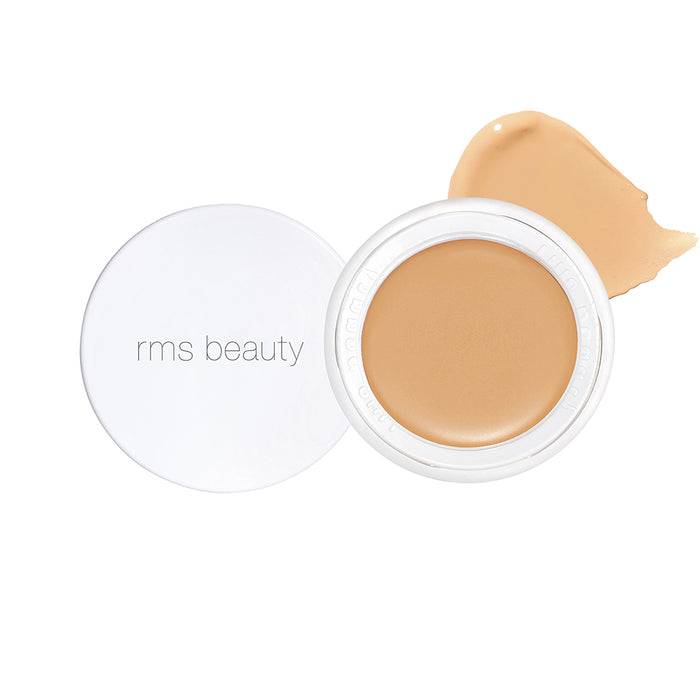 Open jar of UnCoverup Concealer by RMS Beauty showing creamy beige formula with smooth texture on white background, clean beauty makeup with natural ingredients and sustainable packaging.