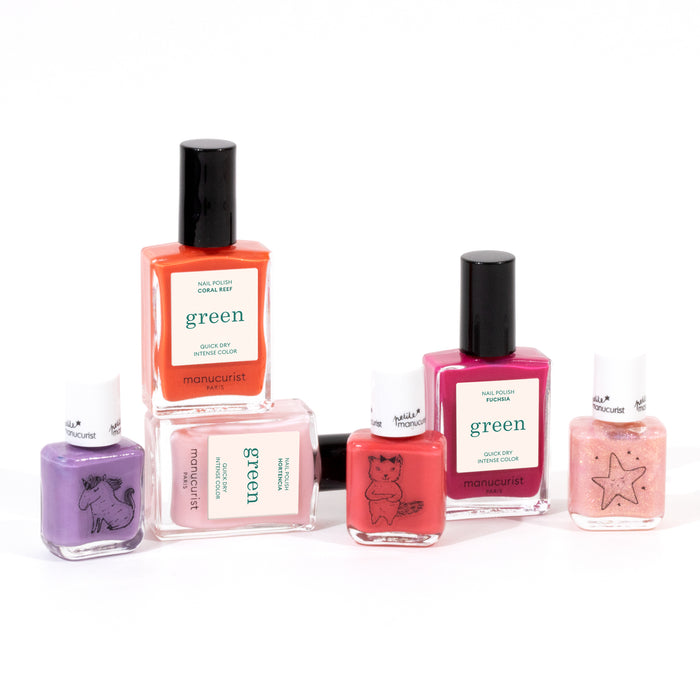 The Manucurist You  Me at a Tea Party Green Set includes six water-based polishes in pink, red, and purple shades—plus a glittery pink—some with playful animal or star illustrations on the bottles.